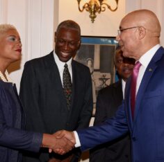 Governor-General Sir Patrick Allen greets Karla Small-Dwyer at King’s House, 17 May 2019. Lincoln McIntyre looks on. Photo: Rudranath Fraser / JIS