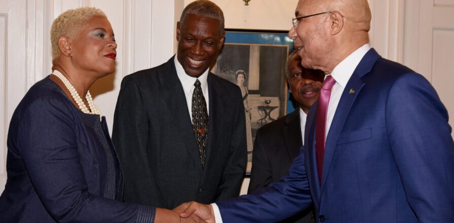 Governor-General Sir Patrick Allen greets Karla Small-Dwyer at King’s House, 17 May 2019. Lincoln McIntyre looks on. Photo: Rudranath Fraser / JIS