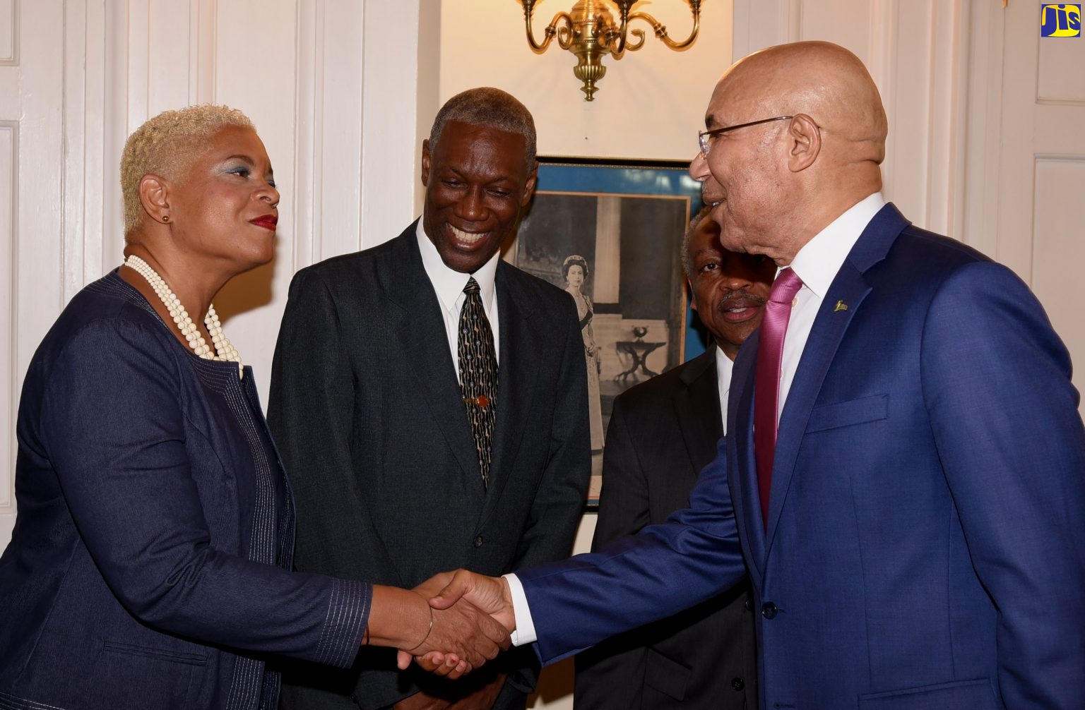 Governor-General Sir Patrick Allen greets Karla Small-Dwyer at King’s House, 17 May 2019. Lincoln McIntyre looks on. Photo: Rudranath Fraser / JIS