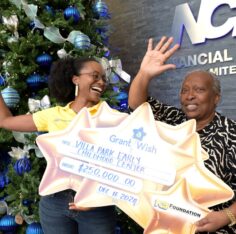 Charlotte Nembhard receives a $200,000 NCB Foundation Grant a Wish cheque. Jamaica Gleaner