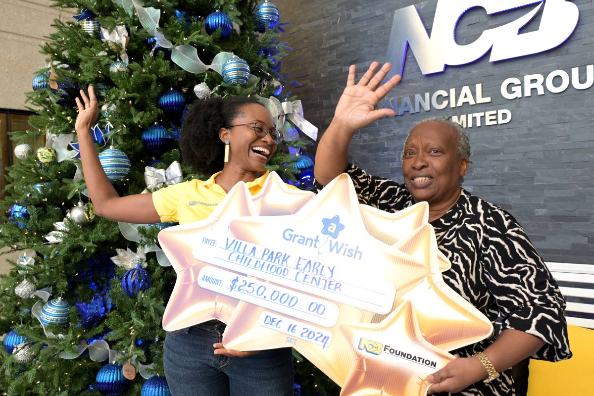 Charlotte Nembhard receives a $200,000 NCB Foundation Grant a Wish cheque. Jamaica Gleaner