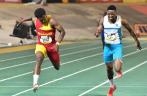 Wolmer’s Boys’ Gary Card wins gold ahead of Rosean Smith of Lacovia in the Boys’ Class One 100m final at Champs. Photo: Naphtali Junior / Jamaica Observer