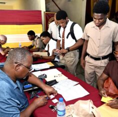 Students and parents with documents at Ready For Life, Wolmer’s Boys’. Photo: Jamaica Gleaner, 4 May 2024.