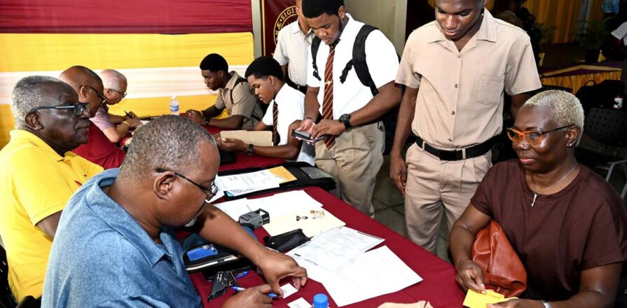 Students and parents with documents at Ready For Life, Wolmer’s Boys’. Photo: Jamaica Gleaner, 4 May 2024.