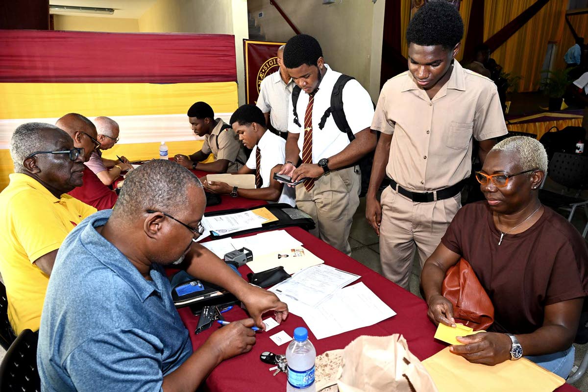 Jeannette Smickle and her son Gavin Watson, with other students, getting documents signed at Ready For Life. Photo: Jamaica Gleaner, 4 May 2024.
