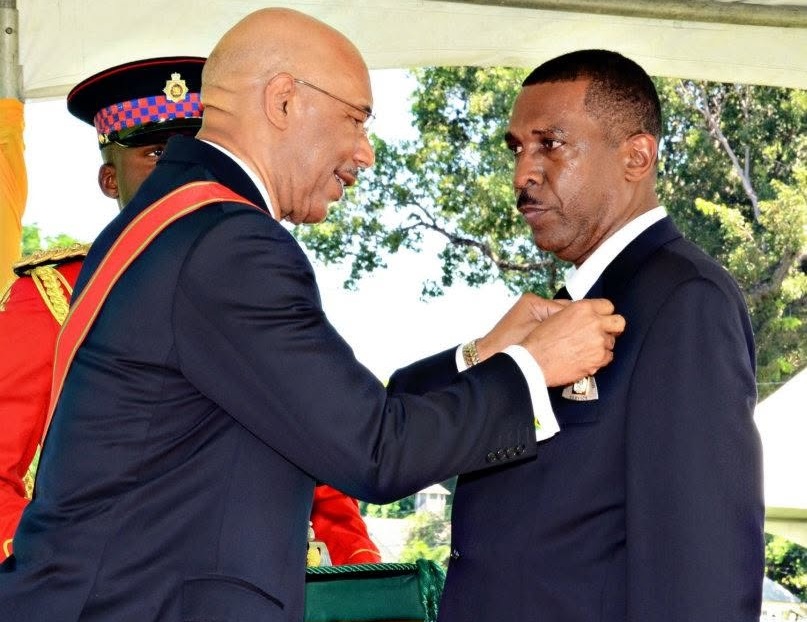Veteran journalist Balford Henry (right) being conferred by Governor-General Sir Patrick Allen with the Order of Distinction (Officer Class) for distinguished service to journalism. Jamaica Observer, 14 September 2026.