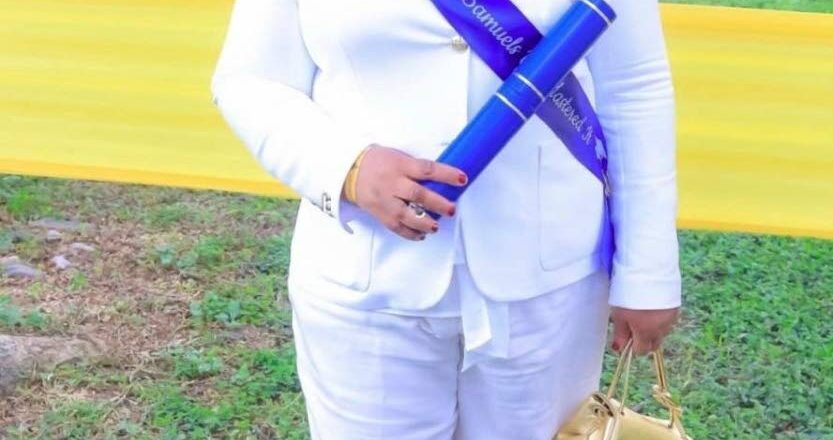 Trecha Thomas poses with her son Jean-Pierre Samuels’ master’s degree. Photo: Contributed. Jamaica Gleaner, 26 September 2026.
