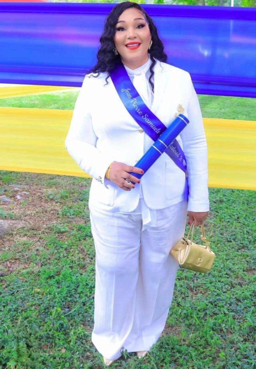 Trecha Thomas poses with her son Jean-Pierre Samuels’ master’s degree, which she collected at his graduation ceremony a few weeks after his death. Photo: Contributed. Jamaica Gleaner, 26 September 2026.