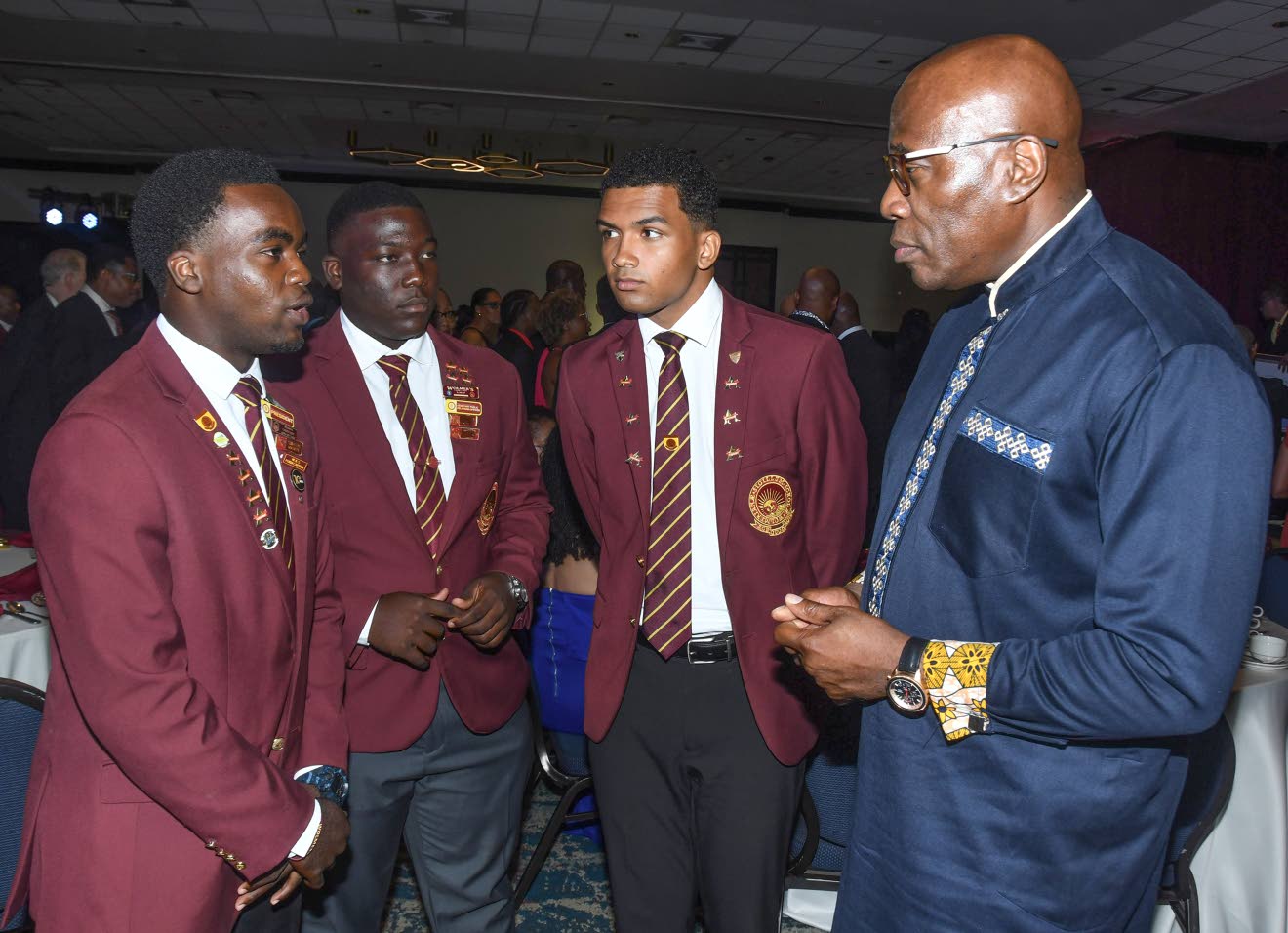 Chief Justice Bryan Sykes with three Wolmer’s Boys’ School sixth-form students at the WOBA 120th anniversary banquet, Jamaica Pegasus. Photo: Naphtali Junior / Jamaica Observer, 10 September 2026.