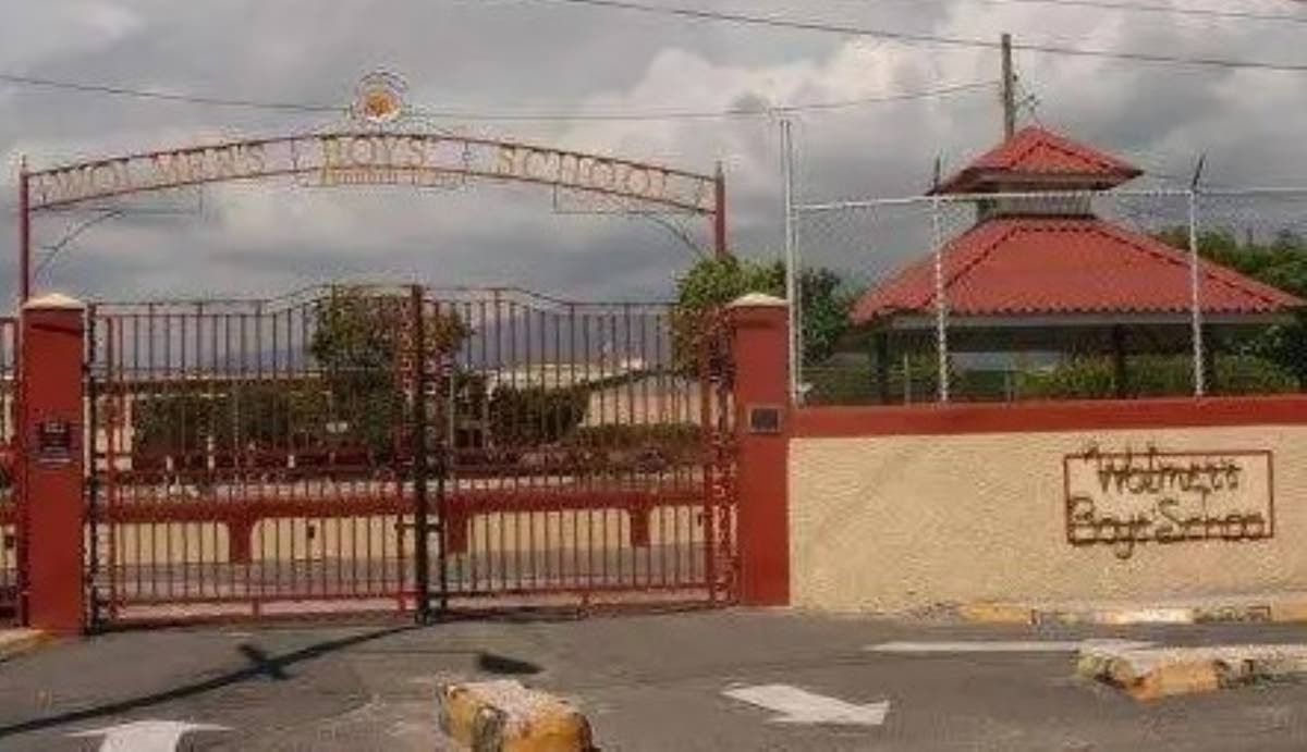 The gate of Wolmer’s Boys’ School. The Jamaica Observer published this as a file photograph with its 28 September 2026 report. The Jamaica Gleaner used the same photograph. It was not taken on the day the student died.