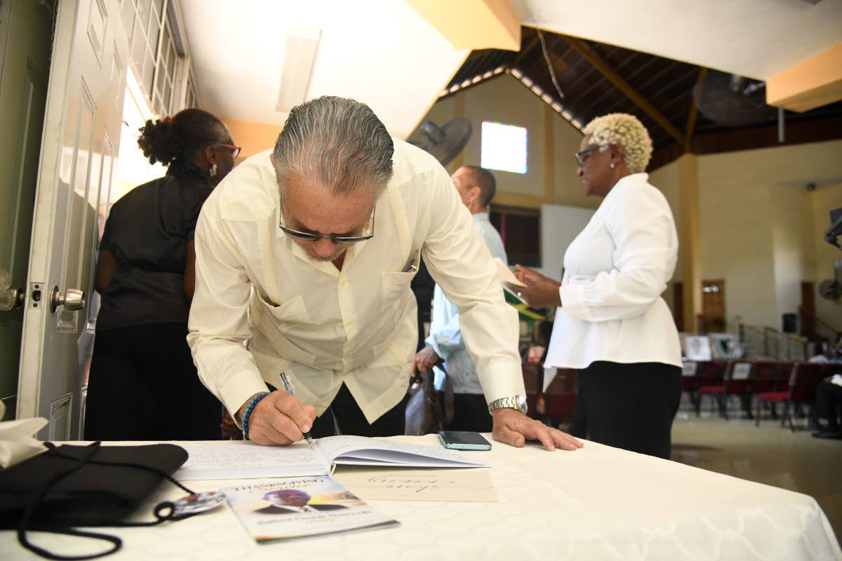 President of the Senate Tom Tavares Finson signs the condolence book for late veteran journalist Balford Henry. Photo - Antoine Lodge Jamaica Gleaner, October 10, 2026.