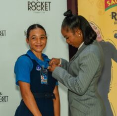 Shelly-Ann Fraser-Pryce, founder and chairwoman of the Pocket Rocket Foundation, pins 2026 scholar Jazmyne Wilkinson during the foundation’s annual scholarship awards at the Wolmer’s Girls’ School Hall on Thursday, September 24. Photo - Contributed Jamaica Gleaner, October 3, 2026.