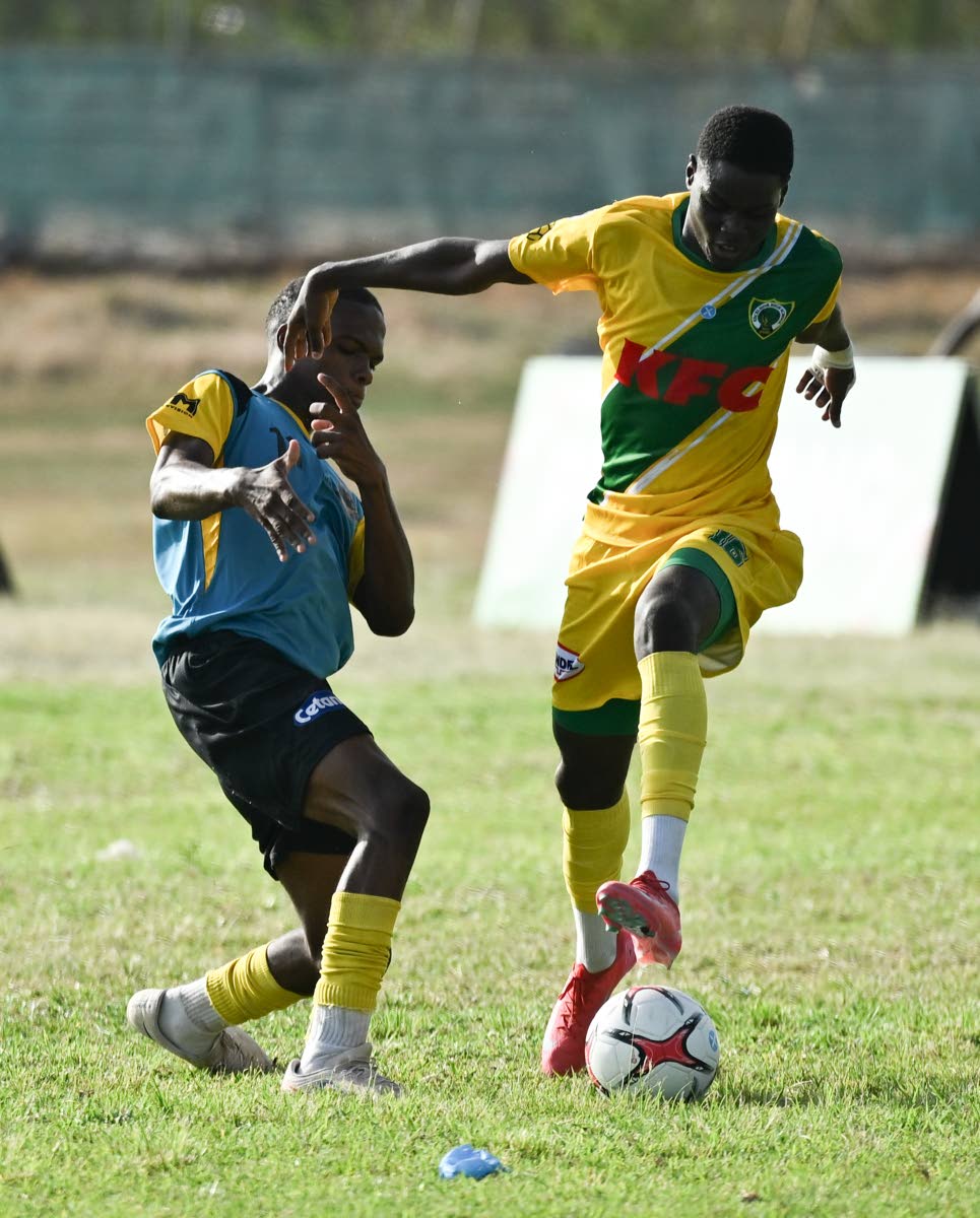 Kingston Technical High School’s Richard West (left) tries to get close to Excelsior High School’s Aldeano Walters during their Walker Cup football encounter at Excelsior High’s playing field on September 26. Photo - Ricardo Makyn Jamaica Gleaner, October 3, 2026.