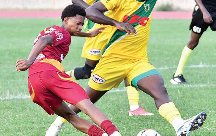 Wolmer’s Boys’ Jude Davis (left) plays the ball while coming under a challenge from Excelsior High’s Tristan Bethune during their ISSA Walker Cup game at the Stadium East Field on Saturday. (Photo: Garfield Robinson) Jamaica Observer, October 4, 2026.