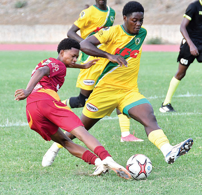 Wolmer’s Boys’ Jude Davis (left) plays the ball while coming under a challenge from Excelsior High’s Tristan Bethune during their ISSA Walker Cup game at the Stadium East Field on Saturday. (Photo: Garfield Robinson) Jamaica Observer, October 4, 2026.